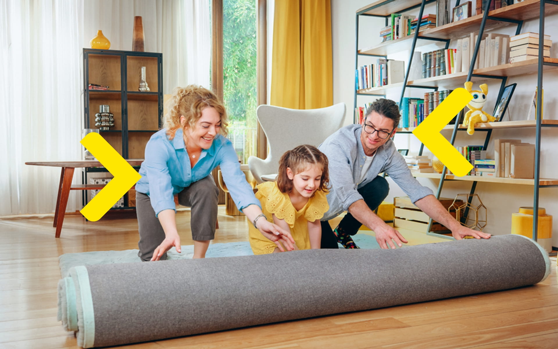 Rodina rozbaluje koberec v novém obývacím pokoji